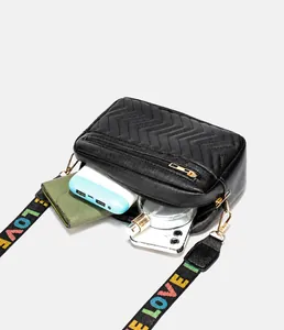 Vue intérieure du sac bandoulière montrant l'espace pour portefeuille et parfum