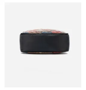 Detailed bottom view of cuboid crossbody bag with precise stitching and colorful patchwork