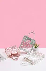 Dreiteiliges Set aus transparenten PVC-Handtaschen mit Gänseblümchen-Muster in Rosa und Grün