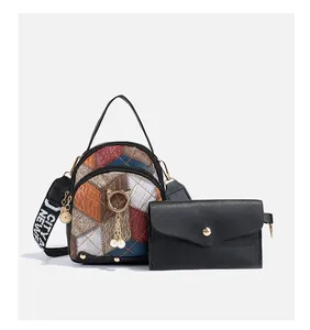 Detail of multi-color crossbody bag with diamond quilting and pearl cat charm set