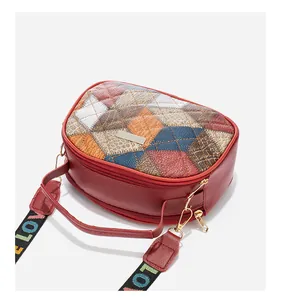 Detail of color-block crossbody bag with quilted texture and double zipper closure