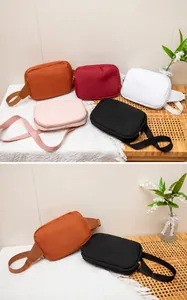 Detailed physical display of lightweight nylon crossbody bags in five assorted colors
