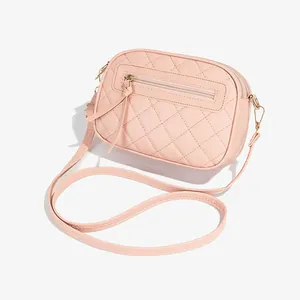 Pink quilted crossbody camera bag with double zippers and gold-tone hardware detail