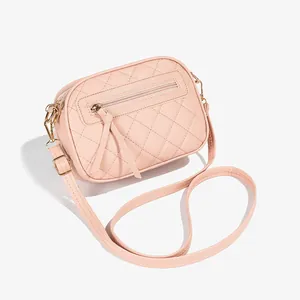 Pink quilted crossbody camera bag for women with gold hardware and adjustable strap