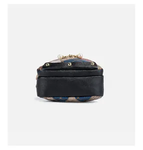 Detail view of colorful quilted bag with gold rivets and smooth leather trim finish