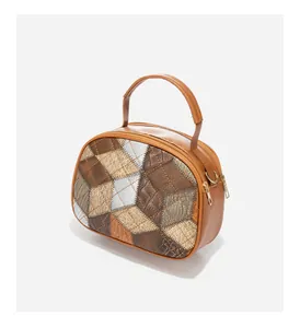 Close-up of retro color-block handbag showing crocodile texture and gold zipper detail