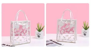 Detail of transparent PVC crossbody bag with white daisy print and faux leather trim