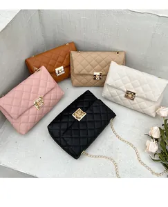 Detail view of quilted leather chain bags in brown, beige, pink and black colors