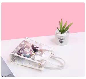 Detailed view of a transparent PVC floral handbag showing spacious storage for cosmetics