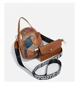 Detail of multi-color quilted crossbody bag with pearl cat charm and wide strap