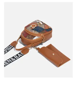 Detail of quilted crossbody bag set with cat charm, pearl pendant and wide logo strap