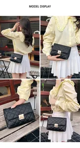 Quilted crossbody bag with gold lock buckle and metal chain strap in outdoor setting