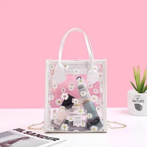 Transparent daisy print PVC handbag with gold chain strap and white trim detail