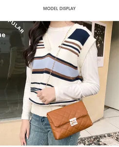 Brown quilted shoulder bag with gold chain strap and turn-lock shown on a model