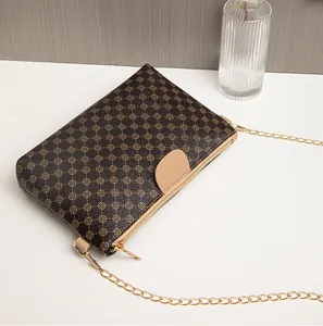 Detail view of vintage patterned crossbody bag with gold chain strap and zipper closure