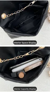 Interior space display of black quilted bag showing capacity for phone and cosmetics