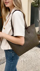 Detailed view of large tote bag with geometric patterns worn by model in urban setting