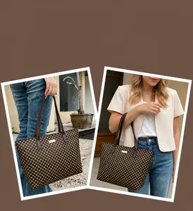 Detail of vintage polka dot tote bag with brown leather handles and gold metal plate