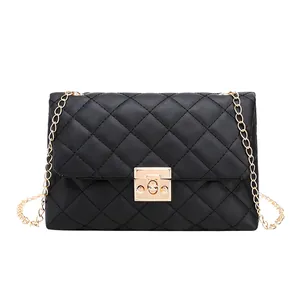 Women's black quilted crossbody bag with gold chain strap and turn-lock closure