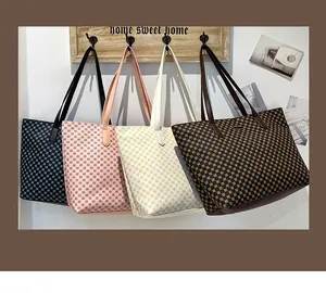 Detail of four colorful tote bags with geometric dot patterns hanging on a wooden rack