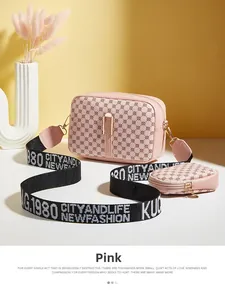 Detail view of pink crossbody camera bag set with round pattern and circle coin purse