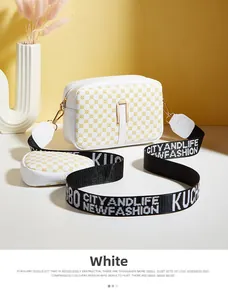 Detailed shot of white camera bag with circular coin purse and wide logo strap