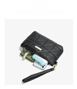 Interior view of black quilted mini bag showing capacity for phone and essentials
