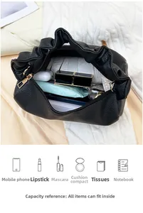 Internal storage of lychee pattern bag showing space for phone and cosmetics
