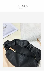 Top view of black litchi pattern leather handbag showing zip closure and gold hardware