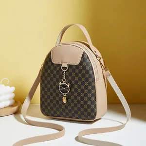 Mini cat backpack for women with contrast printed panels and cat charm in beige