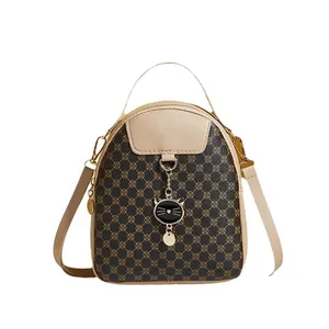 Mini vintage backpack with cat pendant and clover pattern in contrasting colors