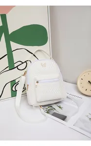Detail of white quilted PU leather mini backpack with golden butterfly clasp and front pocket