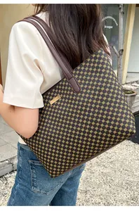 Outdoor lifestyle view of large tote bag with yellow geometric patterns and brown leather handles