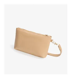 Detail of minimalist khaki PU leather mini bag showing stitching and golden hardware