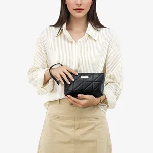 Chic black quilted mini handbag with geometric stitching and silver metal logo tag
