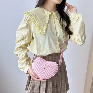 Pink heart-shaped crossbody bag with wave quilted leather and gold hardware