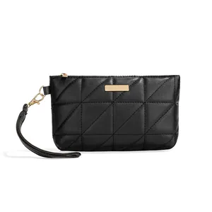 Classic black quilted wristlet handbag with triangle stitching and gold metal hardware