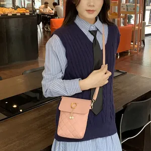 Pink quilted mini crossbody bag with gold cat buckle and pearl pendant for women