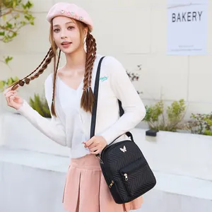 Quilted black crossbody bag with silver butterfly charm for casual travel and daily use