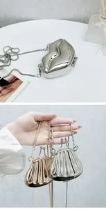 Detailed view of creative lip-shaped silver clutch and metal lantern-style evening bags