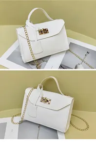 Detail of white leather crossbody bag with golden chain strap and metallic twist-lock