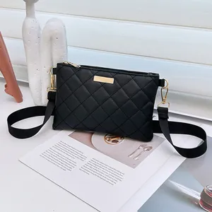 Chic black quilted crossbody bag with golden hardware and wide shoulder strap