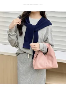 Detail of pink lychee texture leather handbag paired with grey knit lounge outfit