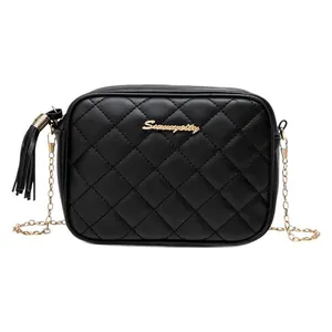 Black quilted crossbody camera bag with gold chain strap and decorative tassel