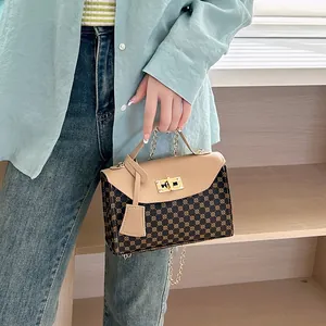 Elegant brown monogram crossbody bag with gold chain strap and stylish scarf handle