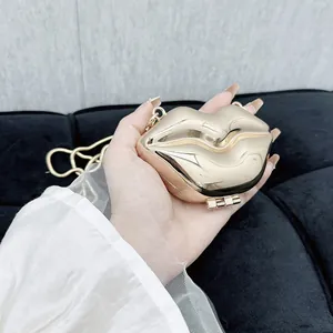 Glossy gold lip-shaped clutch bag with metallic chain strap for evening parties