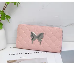 Detail of pink quilted leather long wallet with butterfly metal hardware on magazine