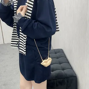 Fashionable gold lip-shaped mini crossbody bag with sleek metal chain strap for women