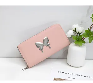 Macro detail of soft pink faux leather long wallet with silver butterfly metal buckle