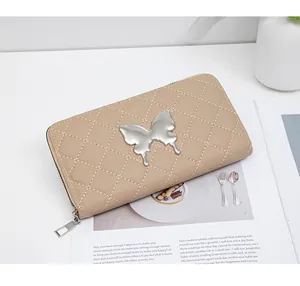 Close-up of khaki quilted leather long wallet with silver butterfly metal buckle